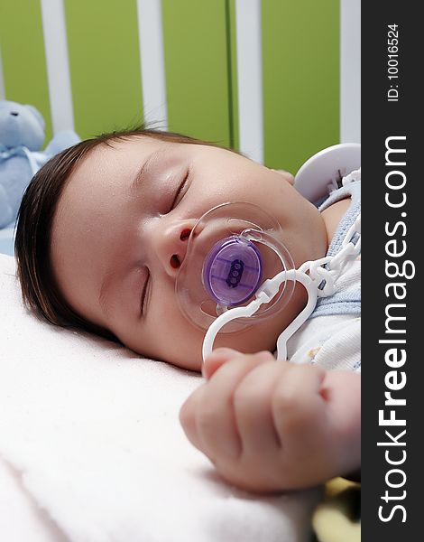 Newborn baby sleeping in bad with dummy. Newborn baby sleeping in bad with dummy