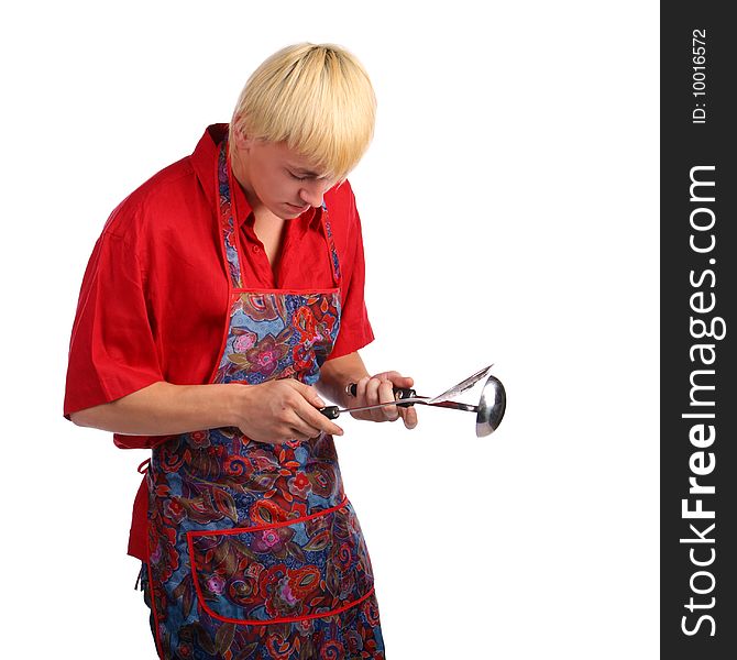 Young man in apron with cook tools