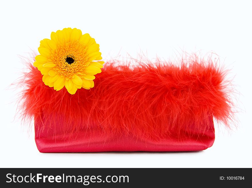 Glamour Girl - vintage red silk evening bag with feathers and Gerbera yellow flower. Isolated on light background. Glamour Girl - vintage red silk evening bag with feathers and Gerbera yellow flower. Isolated on light background.