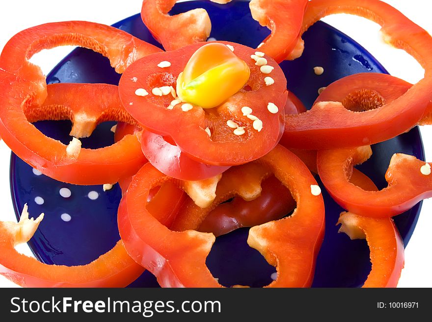 Sliced fresh red pepper on blue dish. Sliced fresh red pepper on blue dish