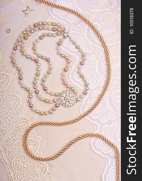 Chain and necklace on lace background. Chain and necklace on lace background