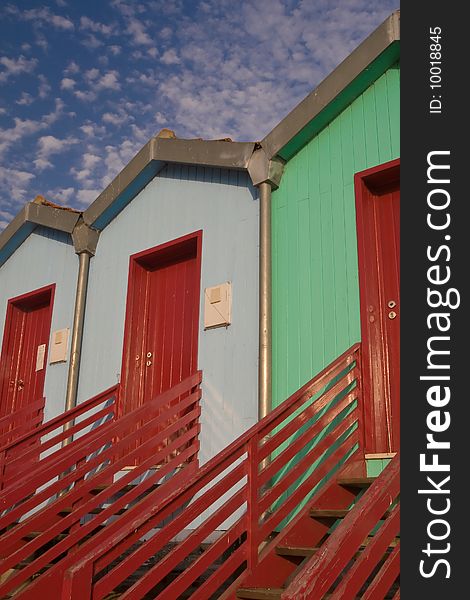 View of three colorful houses with red stairs, Tagus river. View of three colorful houses with red stairs, Tagus river.