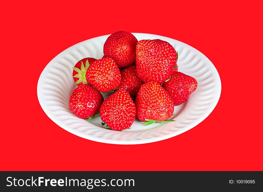 Strawberry in a plate over a red background