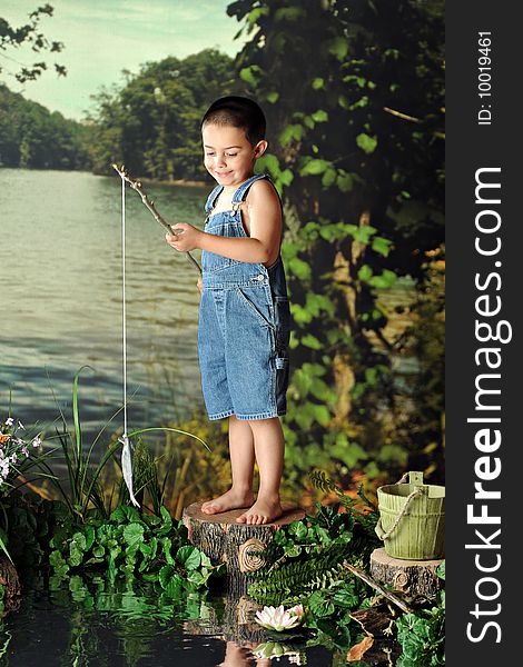 A young, barefoot boy delighted when catching his first fish.