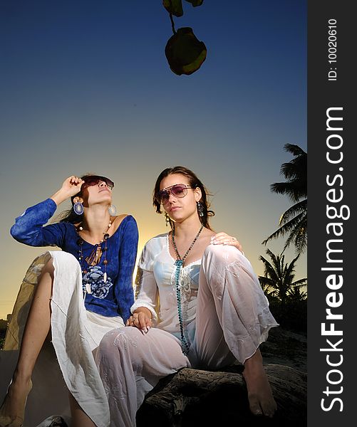 Portrait of two trendy young women on tropical sunset. Portrait of two trendy young women on tropical sunset