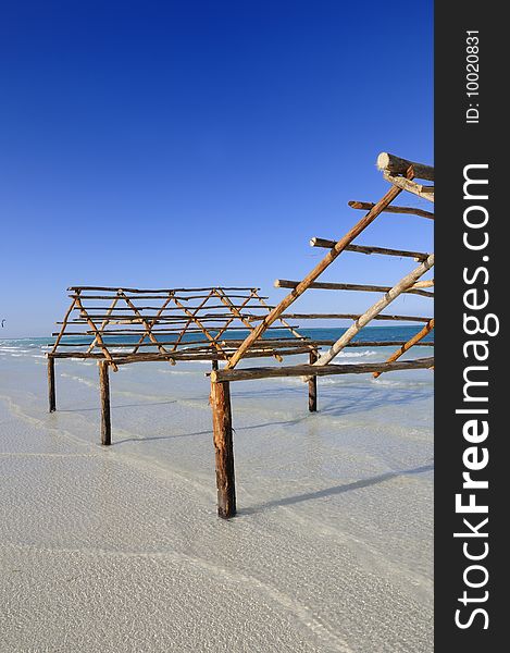 A view of tropical beach with wooden structure, cayo coco, cuba. A view of tropical beach with wooden structure, cayo coco, cuba