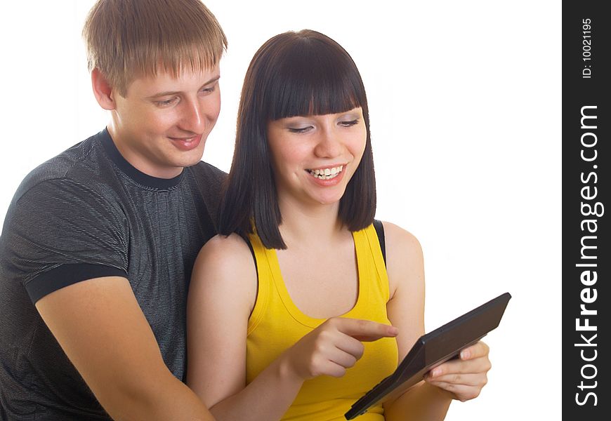 The young couple consider on the calculator together. The young couple consider on the calculator together