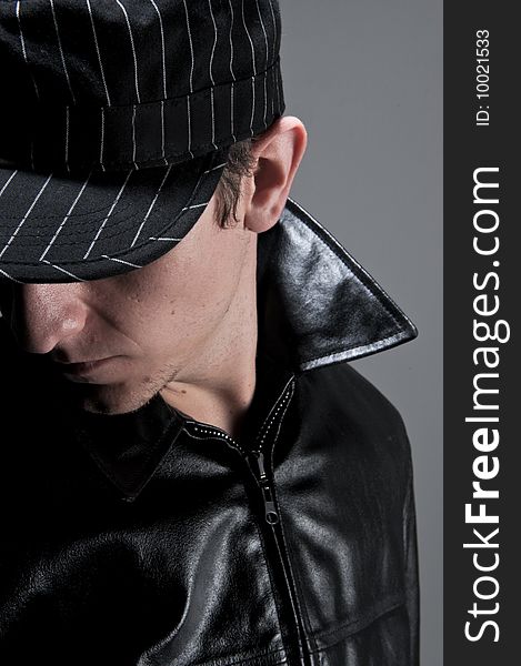 Male model with a black cap and a leather jacket. Male model with a black cap and a leather jacket.