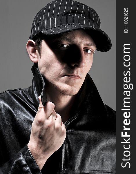 Black hat, black jacket and piercing. a male model is mean. Black hat, black jacket and piercing. a male model is mean.