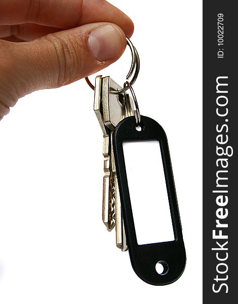 An image of akeys with a keyholder taken by a hand