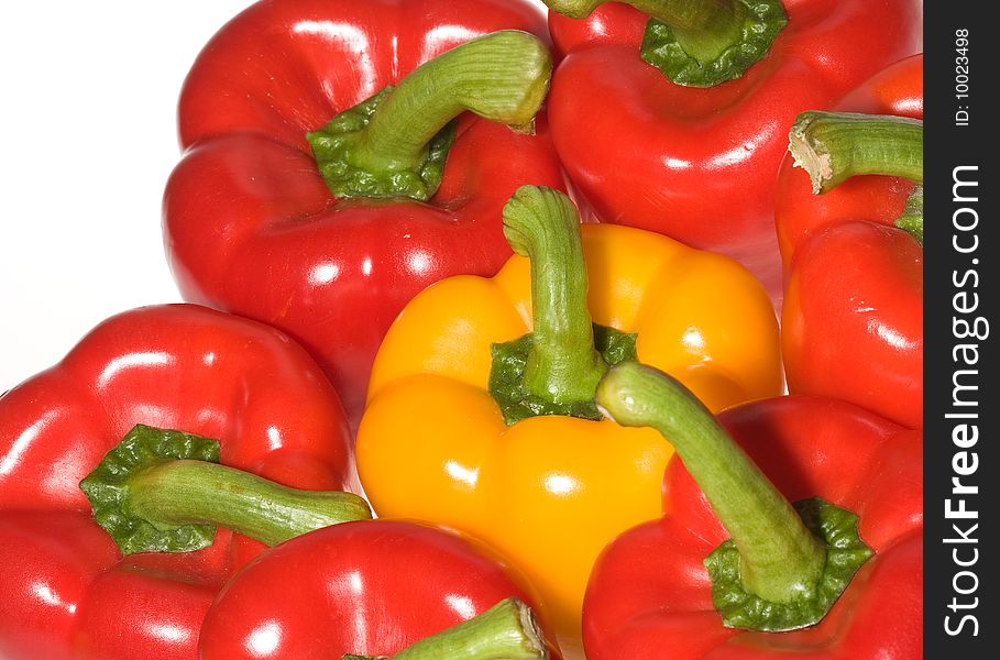 Red and yellow peppers on white background