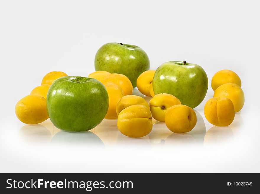Composition from three green apples and yellow an apricot. Composition from three green apples and yellow an apricot