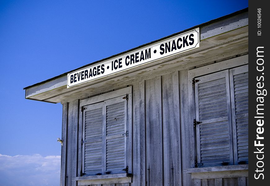 A shuttered up shack sits on a beach. A shuttered up shack sits on a beach