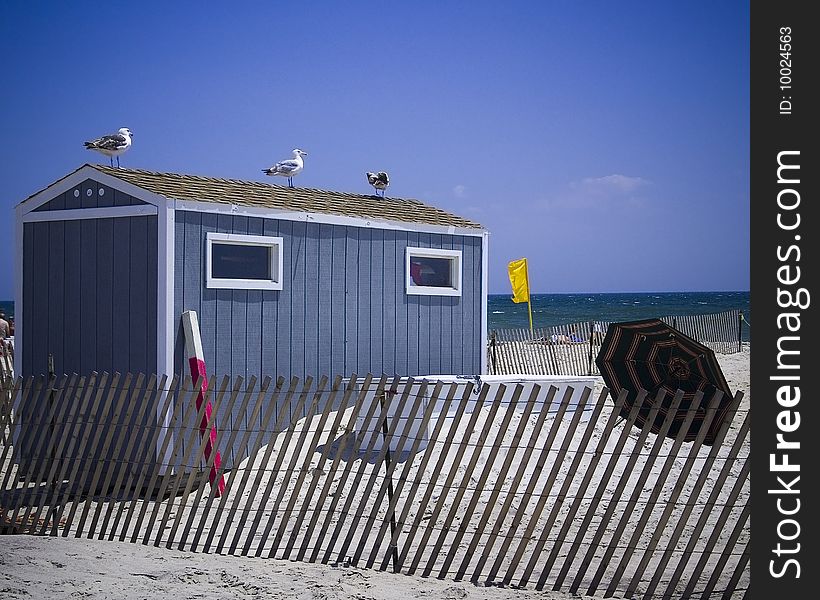 A shuttered up shack sits on a beach. A shuttered up shack sits on a beach