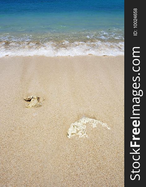 Two rocks buried in the sand. The picture was taken in Hainan, China.