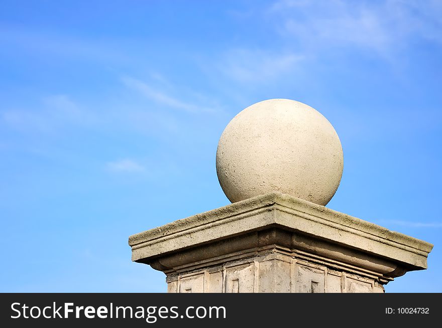 Concrete shpere based on a pillar close up with blue sky as a background. Concrete shpere based on a pillar close up with blue sky as a background