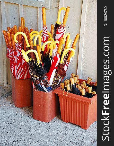 Buckets of colorful assorted umbrellas. Buckets of colorful assorted umbrellas