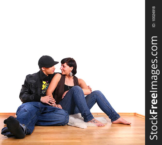 Young stylish couple sitting on the floor of their new home!. Young stylish couple sitting on the floor of their new home!