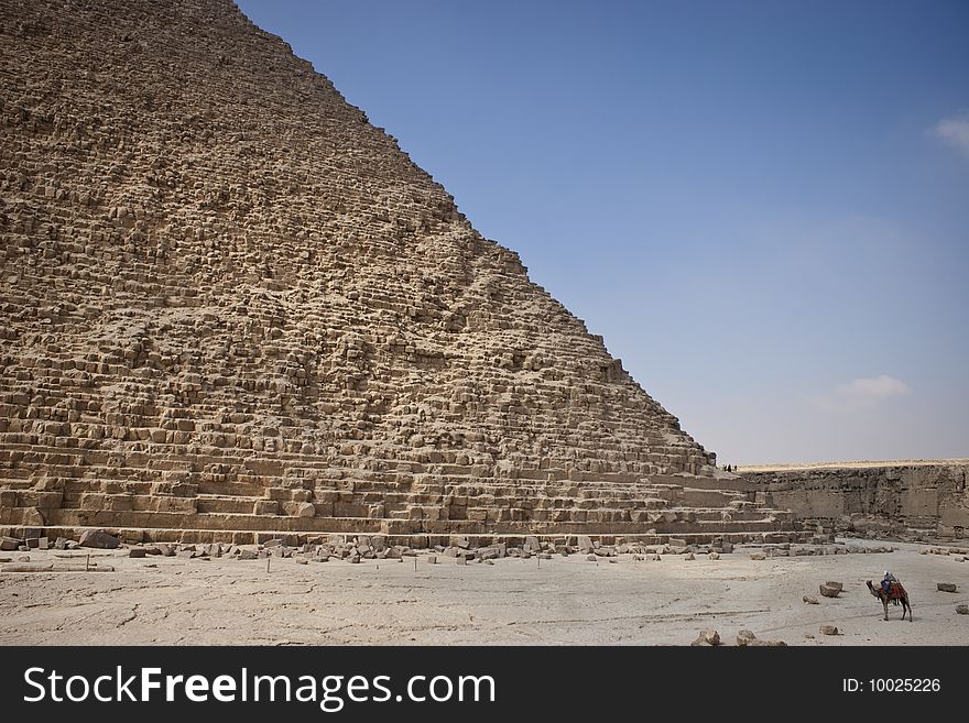 The Pyramid of Khafrae is the second largest of the Ancient Egyptian Pyramids of Giza and the tomb of the fourth-dynasty pharaoh Khafre (Chephren in Greek), The pyramid has a base length of 215.25 m (706 ft) and originally rises to a height of 143.5 m (471 ft). The Pyramid is made of Limestone blocks (weighing more than 2 tons each). The slope of the pyramid rises at an 53� 10' angle, steeper than