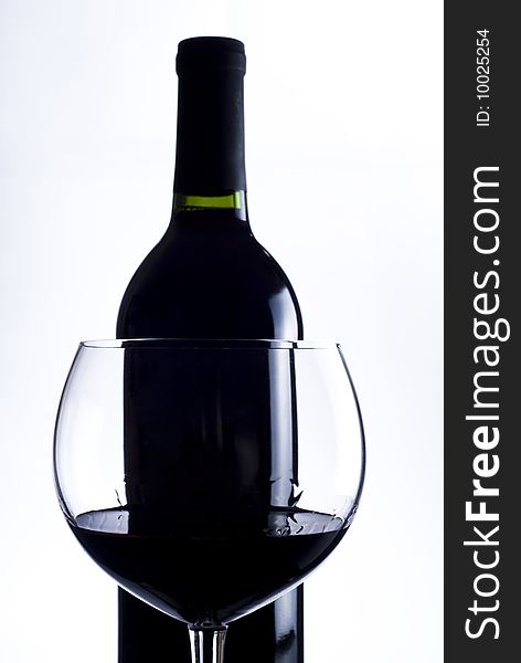 Glass with red wine and bottle of red wine. Glass with red wine and bottle of red wine