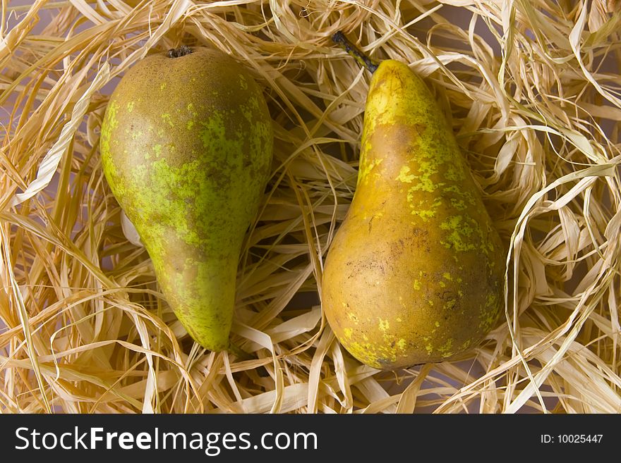 Two pears on a hay background
