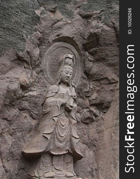 It's a KWAN-YIN stone carving in Wuyi Mountain,Fujian Province,China.
It means peace and heathy.