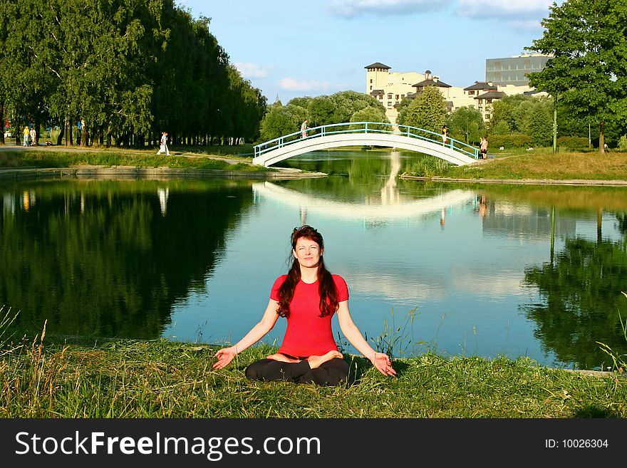 Beautiful young woman meditating in yoga pose outdoors. Beautiful young woman meditating in yoga pose outdoors.
