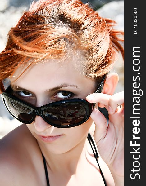 Portrait of pretty atractive woman with red hair and sun-glasses. Portrait of pretty atractive woman with red hair and sun-glasses