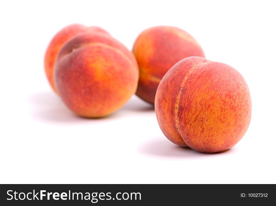 Four peaches on white background