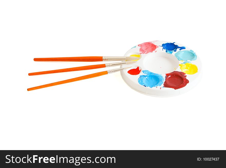 Round kids' palette with three paintbrushes isolated. Round kids' palette with three paintbrushes isolated