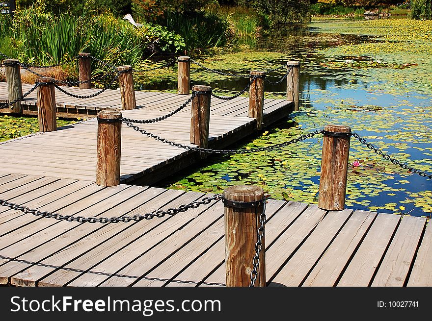 Dock on pond with lilypads