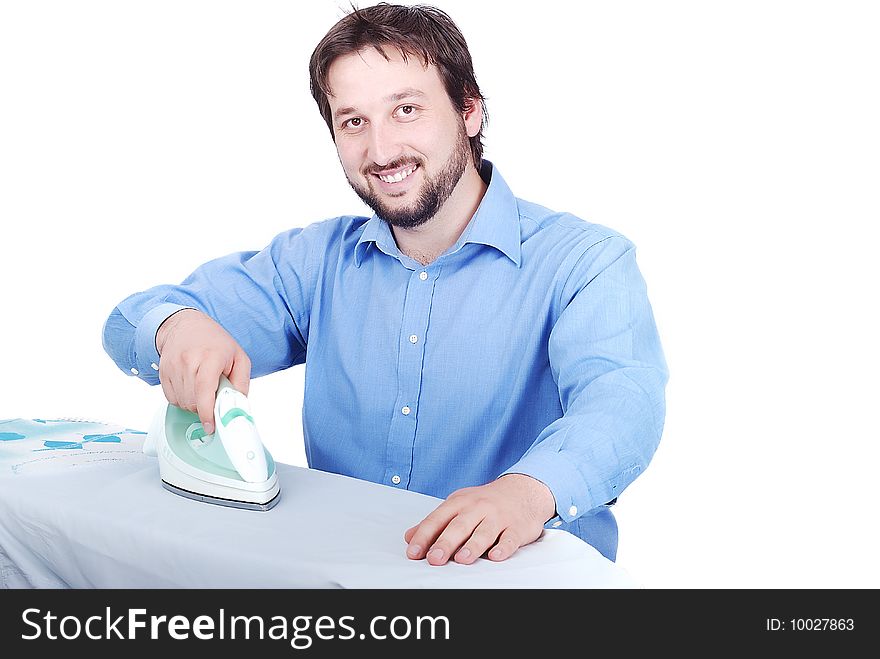 Happy Young Man Ironing Clothes