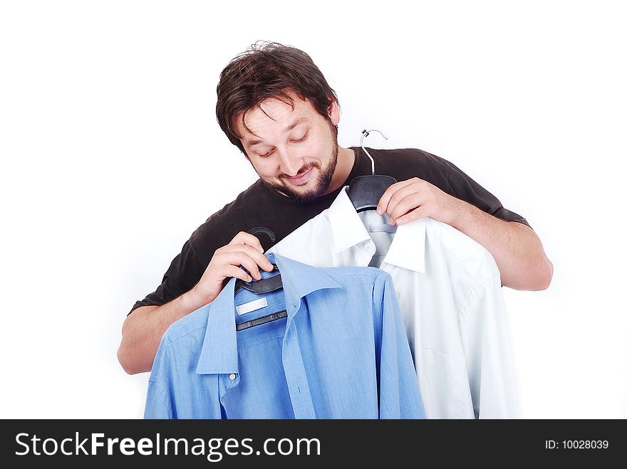 White elegant man with two fasion shirts in hands. White elegant man with two fasion shirts in hands