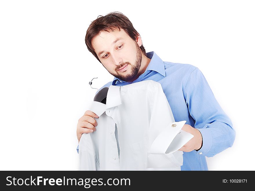 Man is holding two shirts and choosing to wear. Man is holding two shirts and choosing to wear