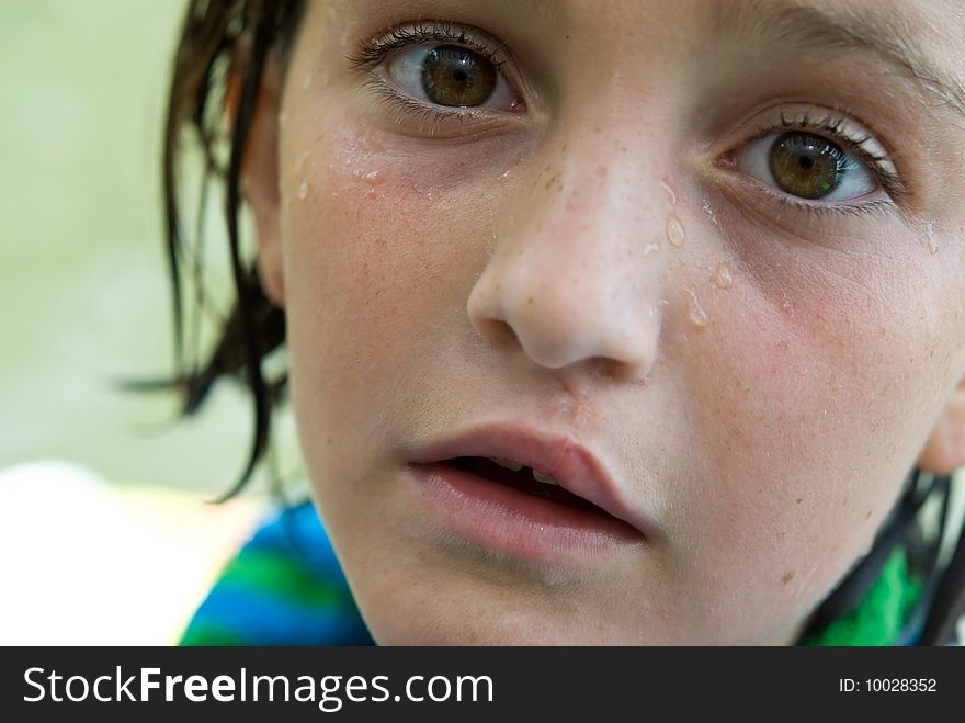 Close up of a wet young girl with an expression of wonderment, interest or curiosity after a bath or swim. Nine years old. Close up of a wet young girl with an expression of wonderment, interest or curiosity after a bath or swim. Nine years old.