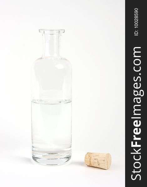 Transparent glass bottle with a cork on a white bakcground. Transparent glass bottle with a cork on a white bakcground.