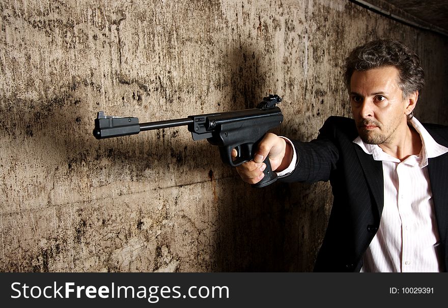 Man killer with gun on dark background