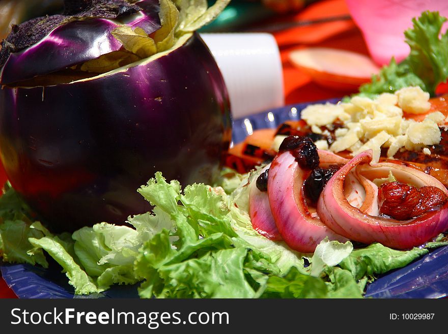 Summer dish consisting of eggplant stuffed with grilled vegetables and crumbs of cheese grana. Summer dish consisting of eggplant stuffed with grilled vegetables and crumbs of cheese grana