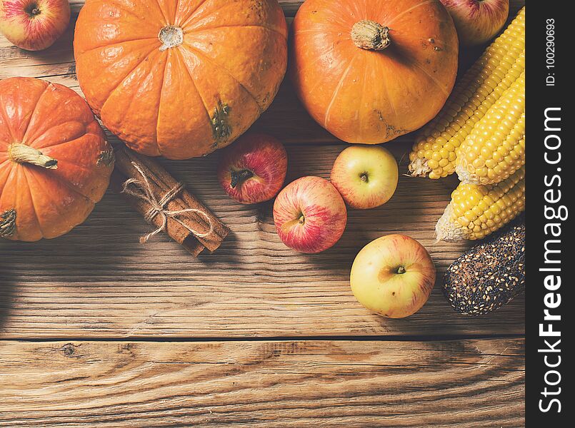 Autumn concept - pumpkins and other vegetables on wooden background. Copy space. Top view