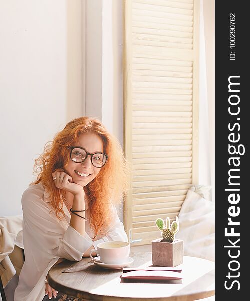 Beautiful Smiling Young Woman With Cup Of Coffee In Cafe.