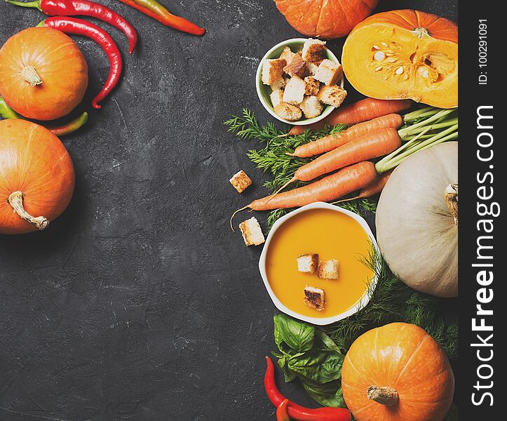 Creamy Pumpkins Soup With Vegetables Over Black Texture