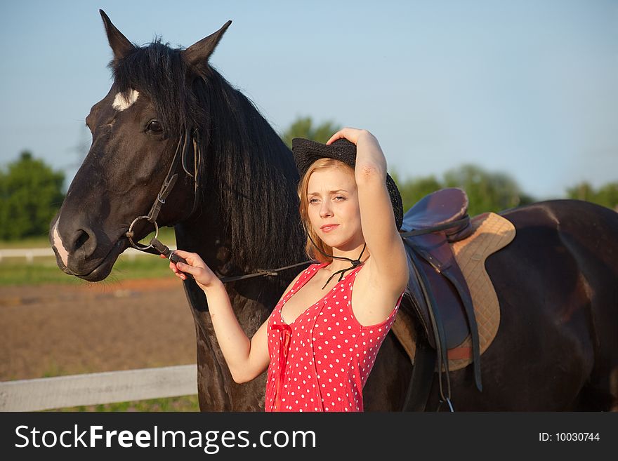 Young blond woman in red dress with horse. Young blond woman in red dress with horse