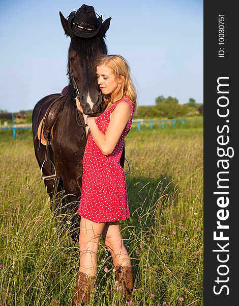 Young blond woman in red dress with horse. Young blond woman in red dress with horse