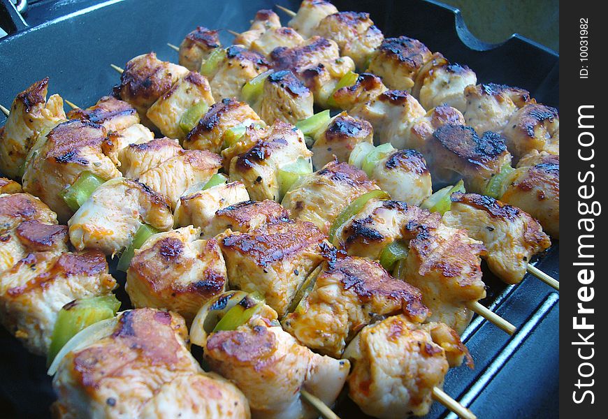 Delicious roasted skewers of chicken with onions and peppers. Delicious roasted skewers of chicken with onions and peppers