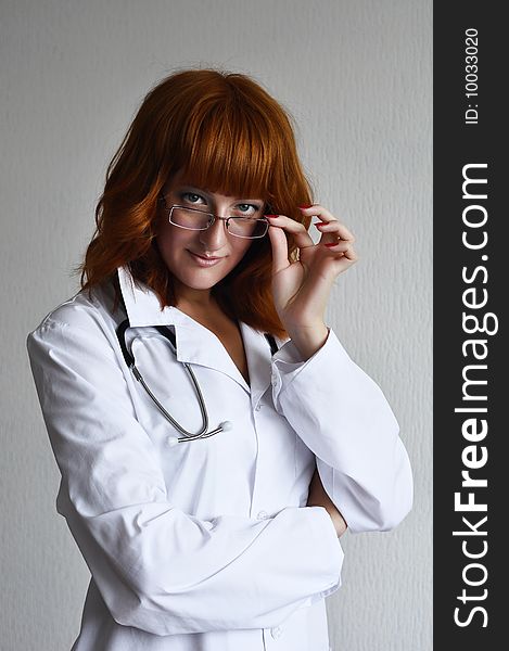 Female Doctor Looking Through Glasses