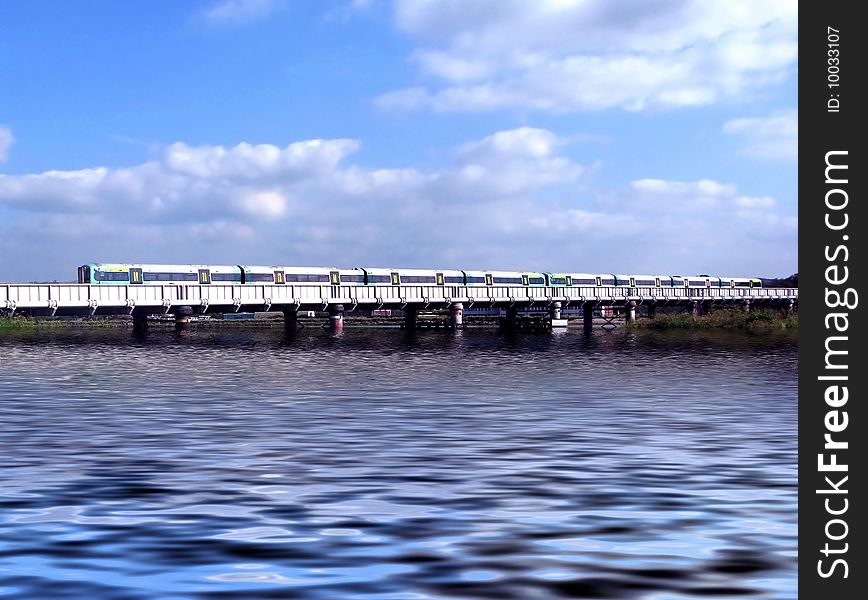 Landscape of commuter train crossing a river