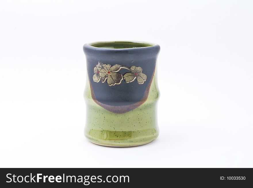 A green cup in a shape of a bamboo. A green cup in a shape of a bamboo