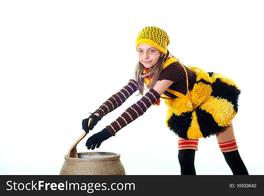 The little girl in a costume cooks food. The little girl in a costume cooks food