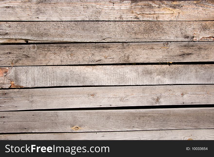 Old wooden fence with old nails