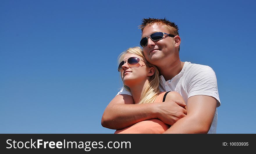 Young couple under clear blue sky. Young couple under clear blue sky